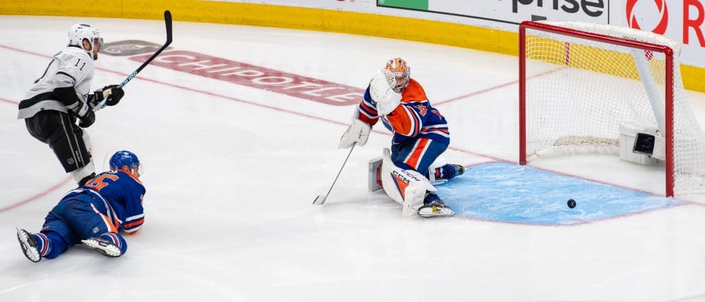 Anze Kopitar #11 of the Los Angeles Kings scores the overtime winning goal against goaltender Stuart Skinner #74 of the Edmonton Oilers in Game Two of the First Round of the 2024 Stanley Cup Playoffs at Rogers Place on April 24, 2024, in Edmonton, Alberta, Canada