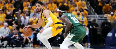 Tyrese Haliburton #0 of the Indiana Pacers attempts a shot while being guarded by AJ Green #20 of the Milwaukee Bucks in the fourth quarter during game three of the Eastern Conference First Round Playoffs at Gainbridge Fieldhouse on April 26, 2024 in Indianapolis, Indiana