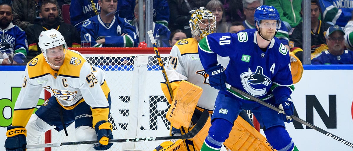 Elias Pettersson and Roman Josi battle for position in the slot in Game 2 (Canucks Predictions)