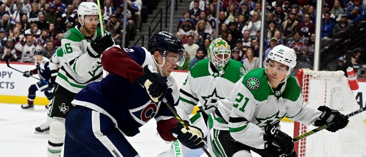 Colorado Avalanche left wing Artturi Lehkonen (62) and Dallas Stars left wing Jason Robertson (21) battle in front of Dallas Stars goaltender Jake Oettinger (29) during the first period at Ball Arena in Denver, Colorado on Sunday, April 07, 2024