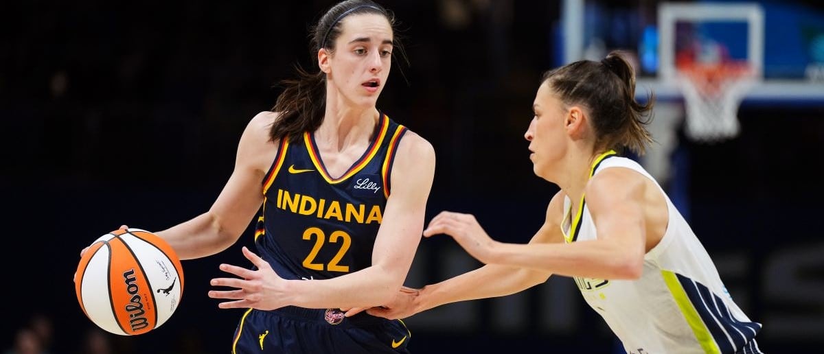 Caitlin Clark #22 of the Indiana Fever handles the ball during the game against the Dallas Wings during the WNBA Preseason Game on May 3, 2024 at the College Park Center in Arlington, Texas.