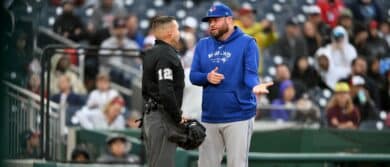 Manager John Schneider #14 of the Toronto Blue Jays argues a call with home plate umpire Jonathan Parra in the fifth inning against the Washington Nationals at Nationals Park on May 04, 2024 in Washington, DC.