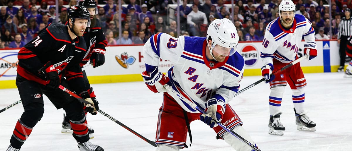 Alexis Lafreniere #13 of the New York Rangers reaches for the puck during the third period of the game against the Carolina Hurricanes at PNC Arena on March 12, 2024 in Raleigh, North Carolina. Rangers defeat Hurricanes 1-0.