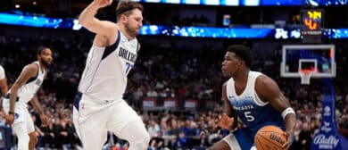 Anthony Edwards #5 of the Minnesota Timberwolves controls the ball as Josh Green #8 of the Dallas Mavericks defends during the second half at American Airlines Center on January 07, 2024 in Dallas, Texas.