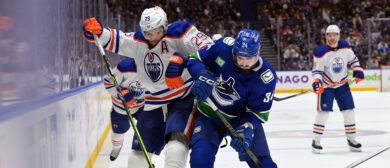 Phillip Di Giuseppe #34 of the Vancouver Canucks and Leon Draisaitl #29 of the Edmonton Oilers fight for the puck during the third period in Game Two of the Second Round of the 2024 Stanley Cup Playoffs at Rogers Arena on May 10, 2024 in Vancouver, British Columbia. (Oilers predictions)