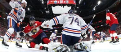 Matthew Tkachuk #19 of the Florida Panthers slides between goaltender Stuart Skinner #74 and Mattias Ekholm #14 of the Edmonton Oilers during the third period of Game Two of the 2024 Stanley Cup Final between the Edmonton Oilers and the Florida Panthers at Amerant Bank Arena on June 10, 2024 in Sunrise, Florida.