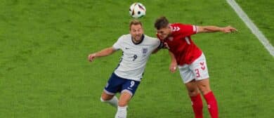 Harry Kane (L) of England jumps to the ball with Jannik Vestergaard (R) of Denmark during the UEFA EURO 2024 group stage match between Denmark and England at Frankfurt Arena on June 20, 2024 in Frankfurt am Main, Germany.