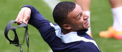 France's forward #10 Kylian Mbappe throws his protective face mask as he jokes during a training session within the UEFA Euro 2024 Football Championship at the Home Deluxe Arena Stadium in Paderborn, western Germany, on June 23, 2024.