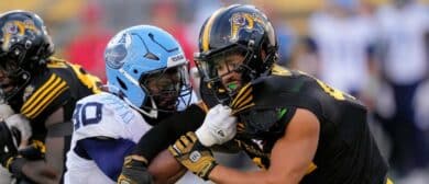 Jonathan Jones #30 of the Toronto Argonauts and Trevor Hoyte #42 of the Hamilton Tiger-Cats battle along the line of scrimmage on a punt at Tim Hortons Field on July 20, 2024 in Hamilton, Canada.