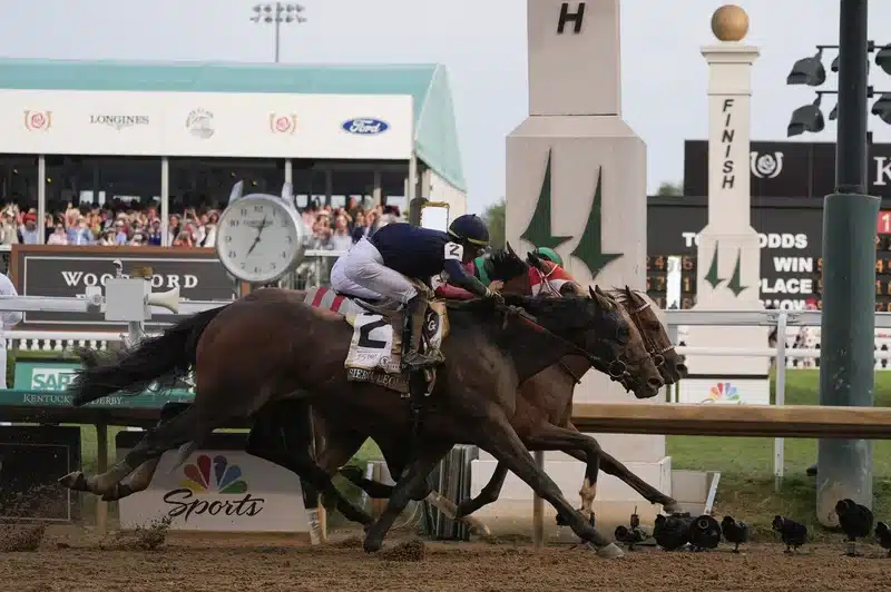 Sierra Leone, with jockey Tyler Gaffalione, (2), Forever Young, with jockey Ryusei Sakai, and Mystik Dan, with jockey Brian Hernandez Jr., cross the finish line at Churchill Downs during the 150th running of the Kentucky Derby horse race Saturday, in Louisville, Ky.