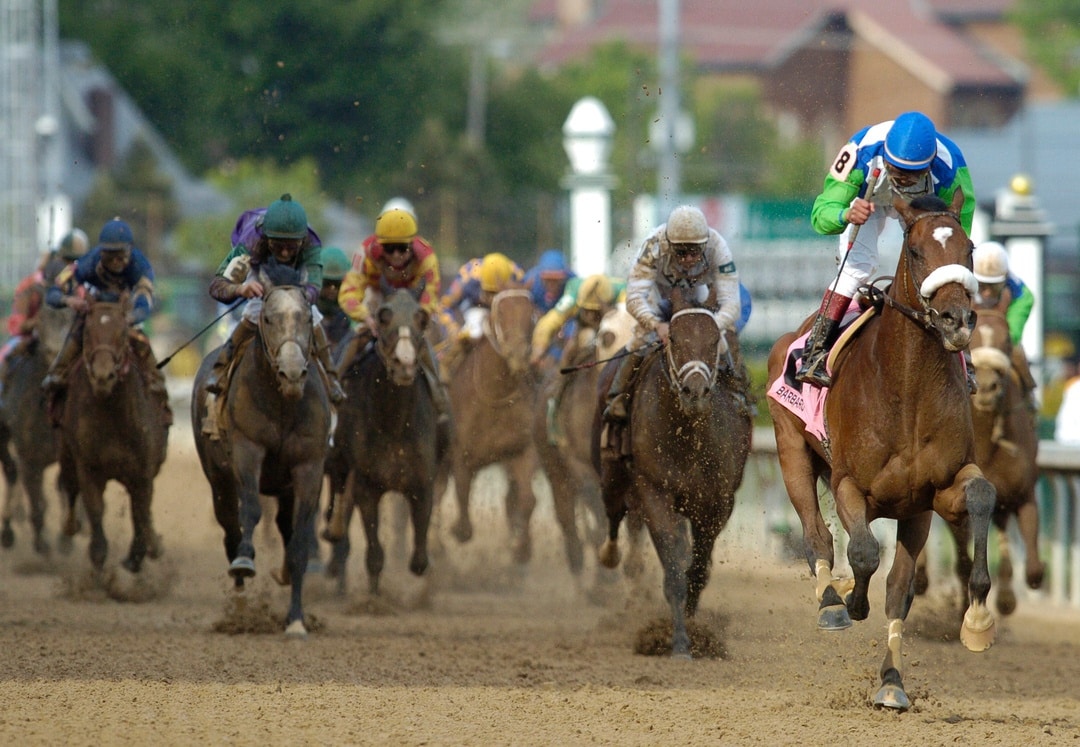 Edgar Prado raises his fist in celebration as he and Barbaro cross the finish line after winning the 132nd Kentucky Derby on May 6, 2006 before the second-largest crowd at Churchill Downs.