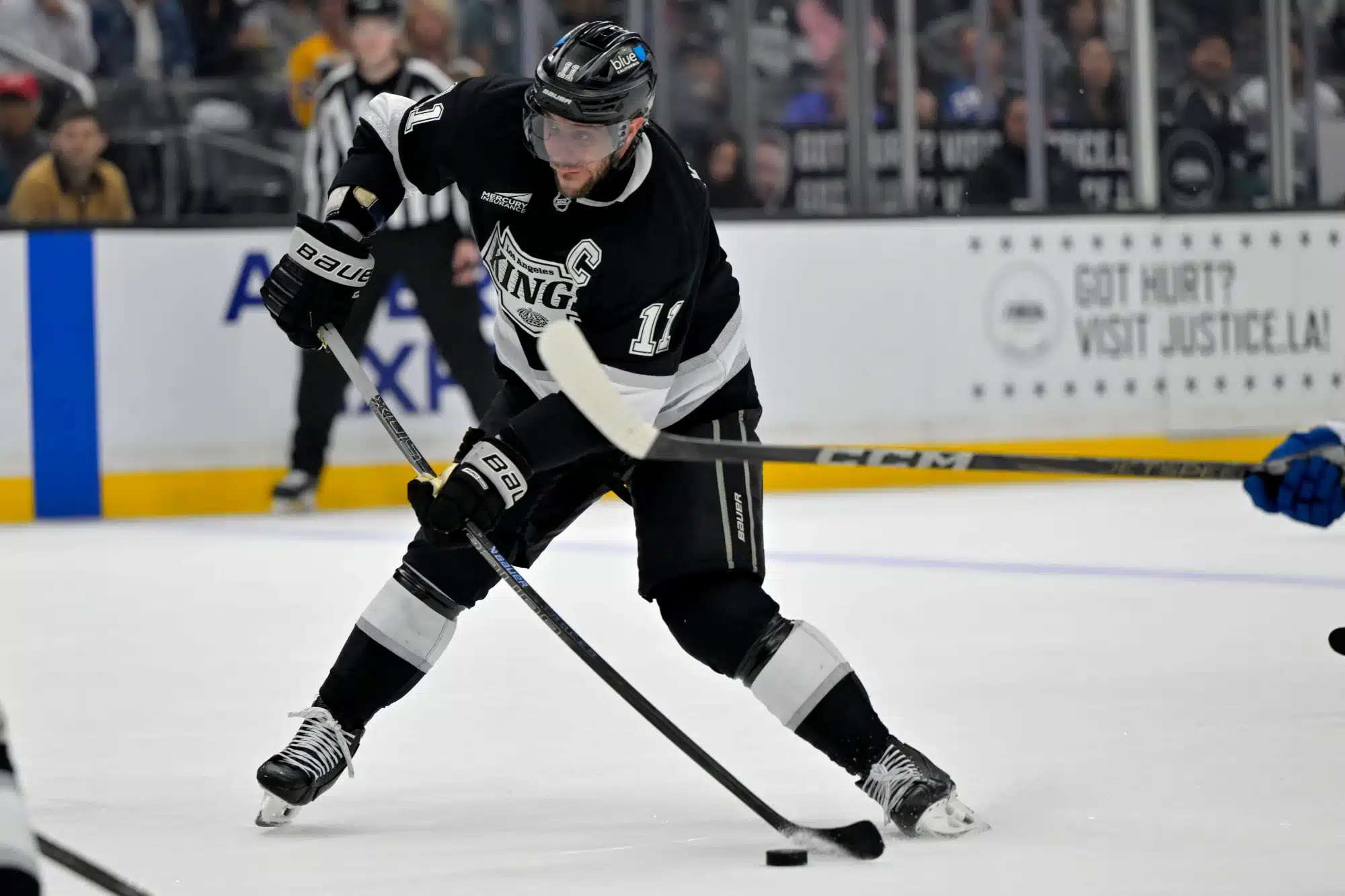 Apr 12, 2025; Los Angeles, California, USA; Los Angeles Kings center Anze Kopitar (11) takes a shot on goal in the second period against the Colorado Avalanche at Crypto.com Arena.