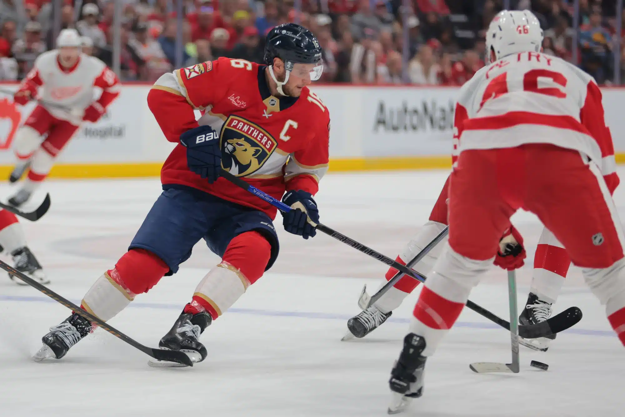 Apr 10, 2025; Sunrise, Florida, USA; Florida Panthers center Aleksander Barkov (16) moves the puck against Detroit Red Wings defenseman Jeff Petry (46) during the first period at Amerant Bank Arena.