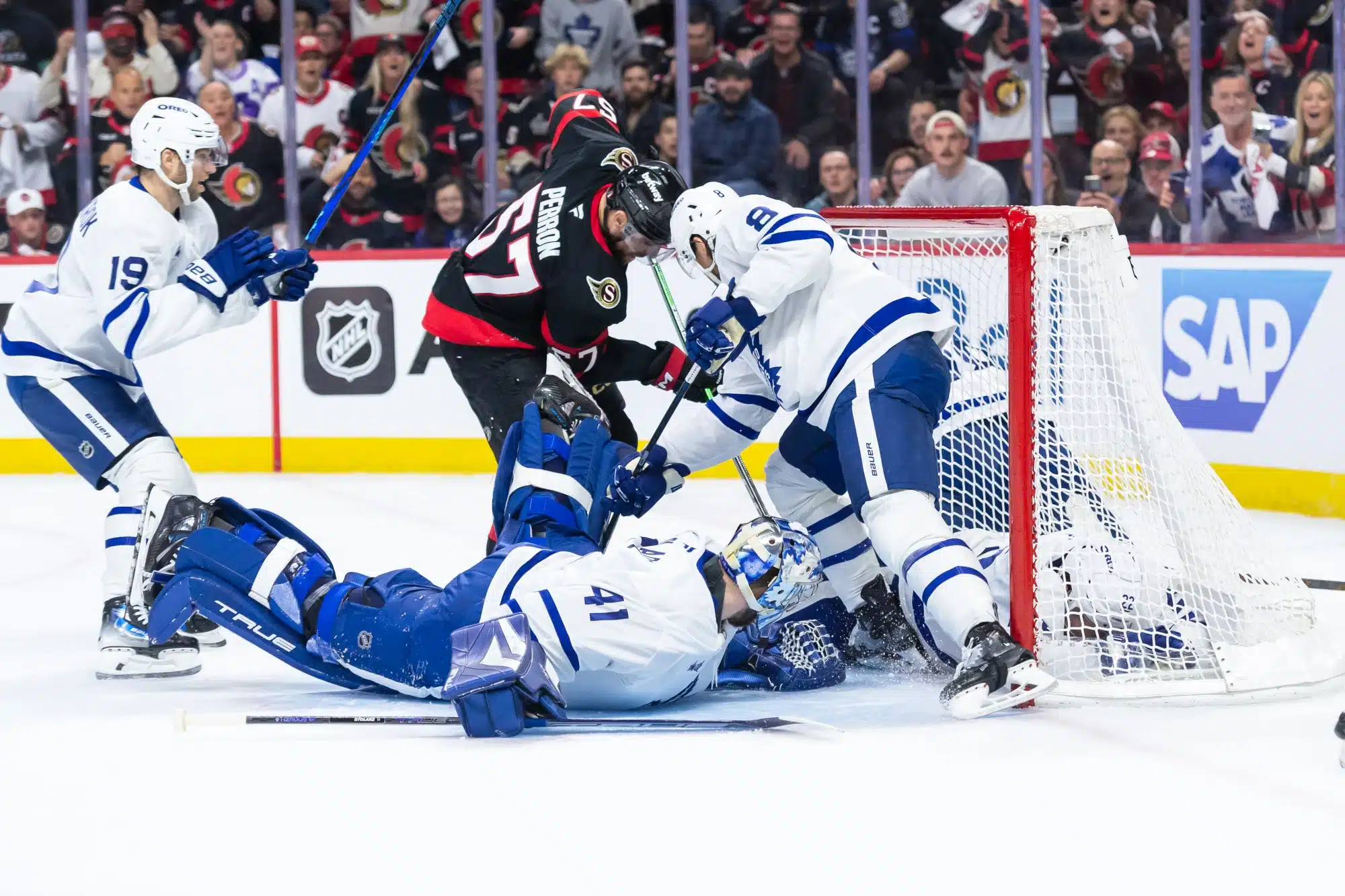 Apr 26, 2025; Ottawa, Ontario, CAN; Toronto Maple Leafs goalie Anthony Stolarz (41) makes a save in front of Ottawa Senators left wing David Perron (57) in game four of the first round of the 2025 Stanley Cup Playoffs at Canadian Tire Centre. 