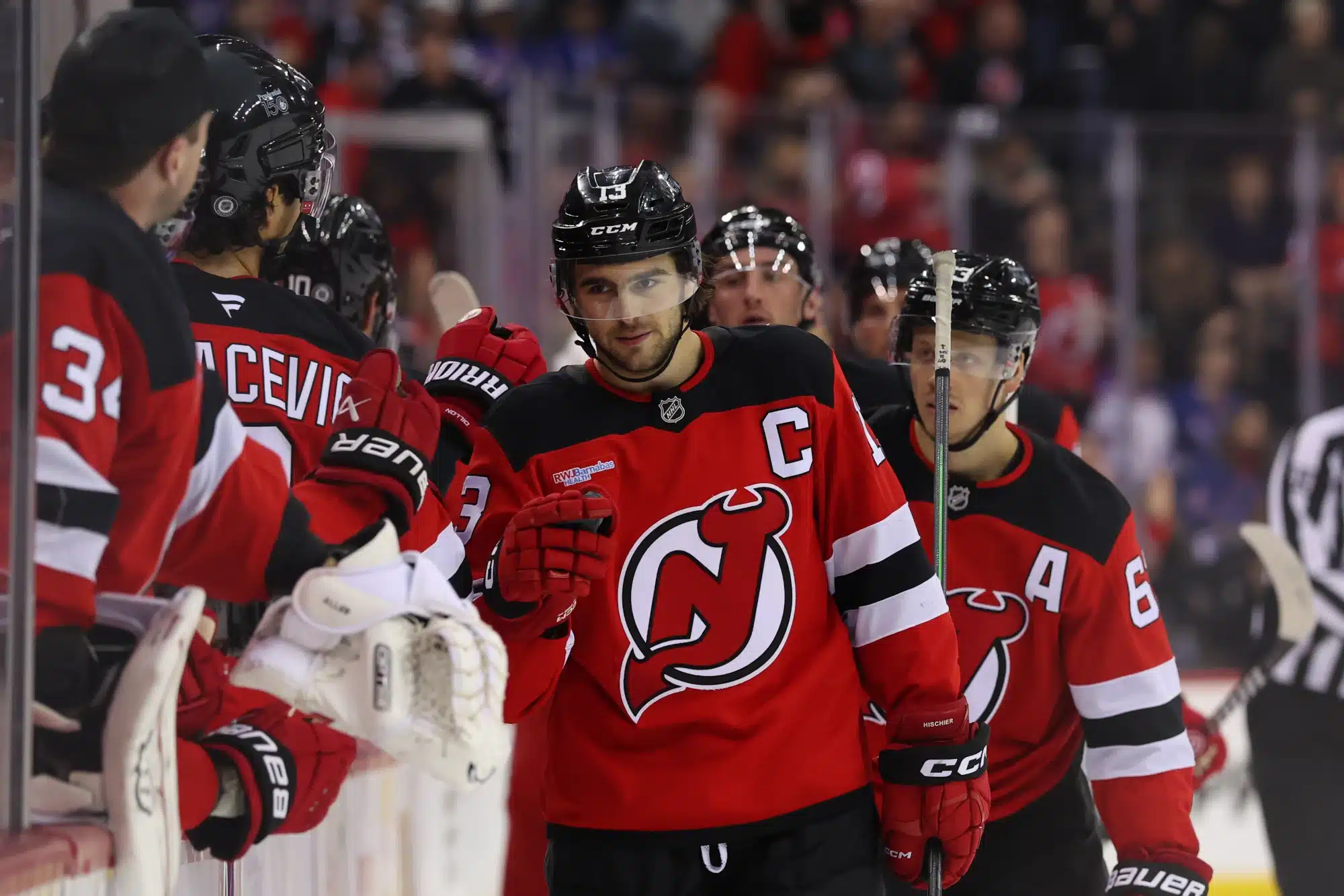 Apr 5, 2025; Newark, New Jersey, USA; New Jersey Devils center Nico Hischier (13) celebrates his goal against the New York Rangers during the third period at Prudential Center.