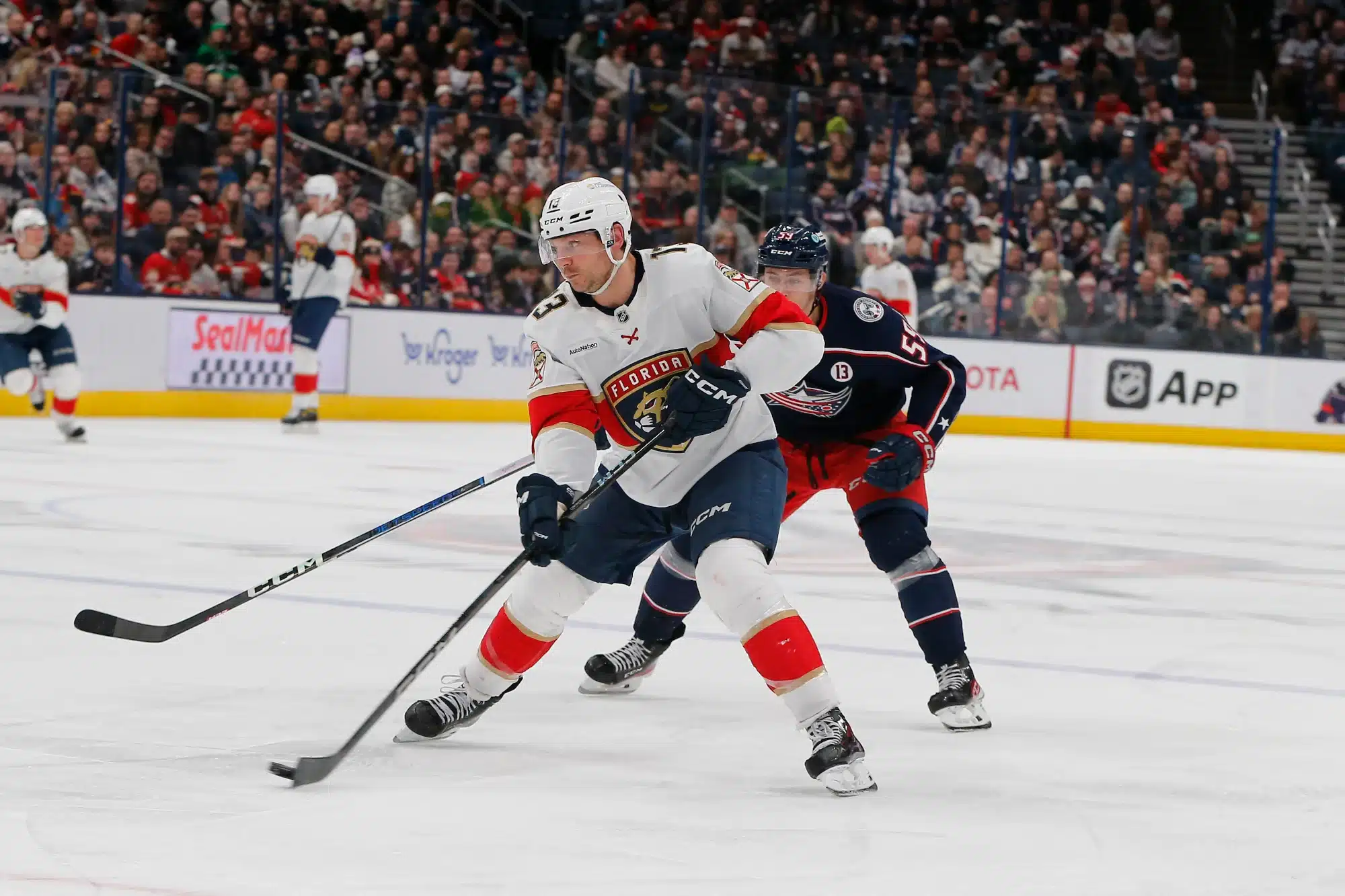 Mar 20, 2025; Columbus, Ohio, USA; Florida Panthers center Sam Reinhart (13) passes the puck asColumbus Blue Jackets right wing Yegor Chinakhov (59) trails the play during the third period at Nationwide Arena.