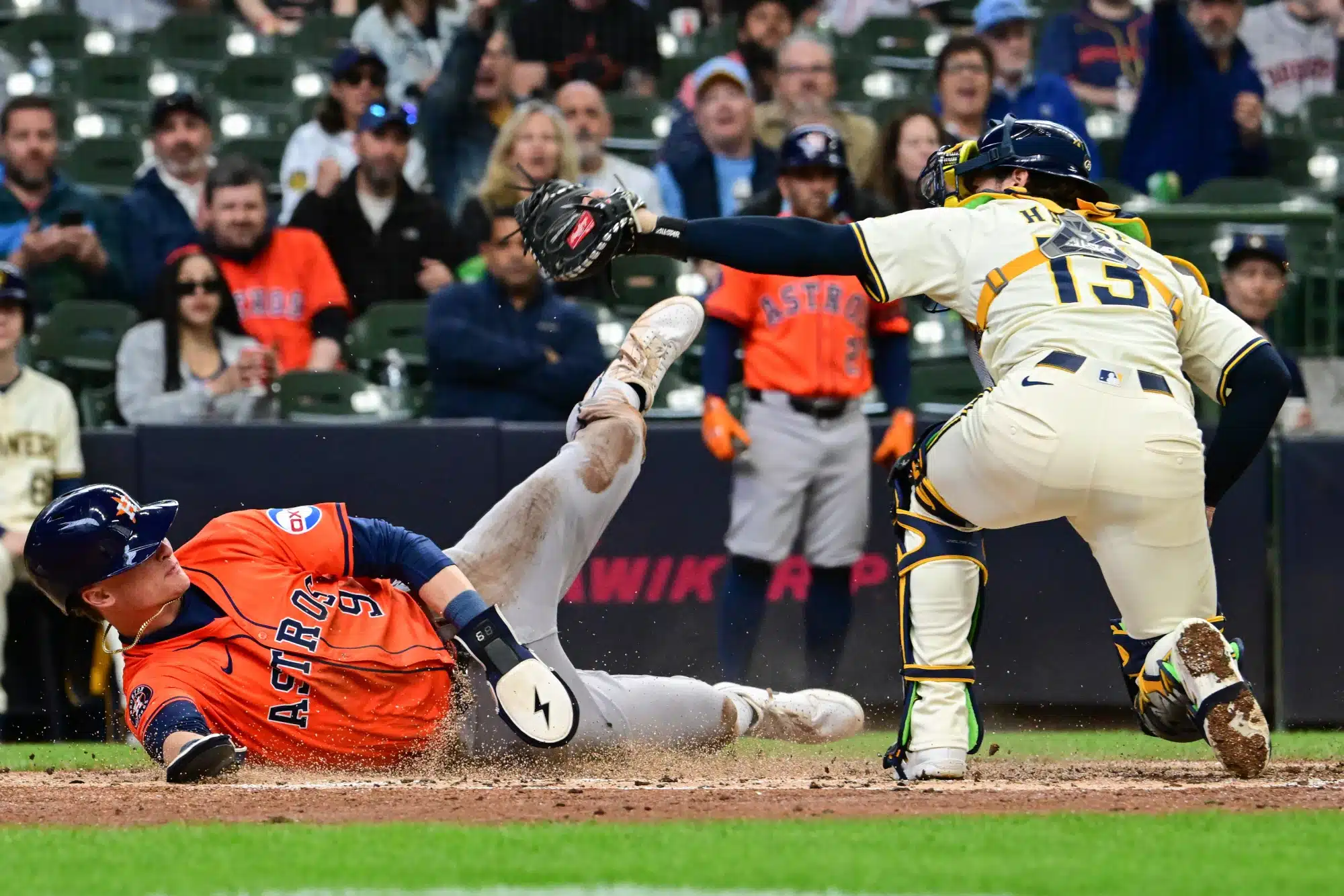 May 7, 2025; Milwaukee, Wisconsin, USA; Houston Astros left fielder Zach Dezenzo (9) scores ahead of the tag by Milwaukee Brewers catcher Eric Haase (13) in the fifth inning at American Family Field.