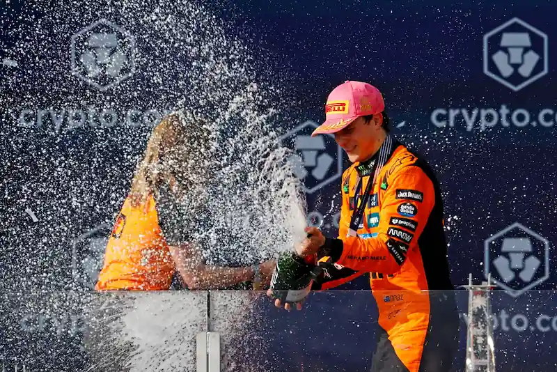 May 4, 2025; Miami Gardens, FL, USA; McLaren driver Oscar Piastri (81) sprays champagne at the crowd after winning the F1 Miami Grand Prix at Miami International Autodrome.