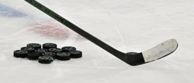 A view of a hockey stick and pucks before the game between the Dallas Stars and the Colorado Avalanche in game seven of the first round of the 2025 Stanley Cup Playoffs at American Airlines Center.