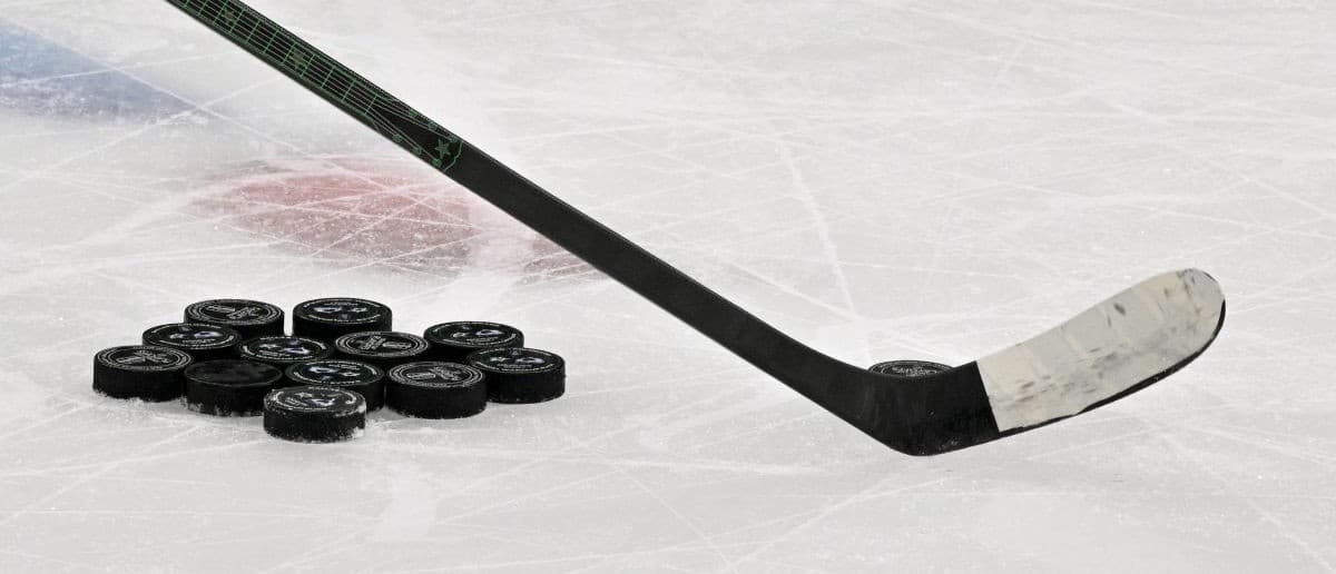 A view of a hockey stick and pucks before the game between the Dallas Stars and the Colorado Avalanche in game seven of the first round of the 2025 Stanley Cup Playoffs at American Airlines Center.
