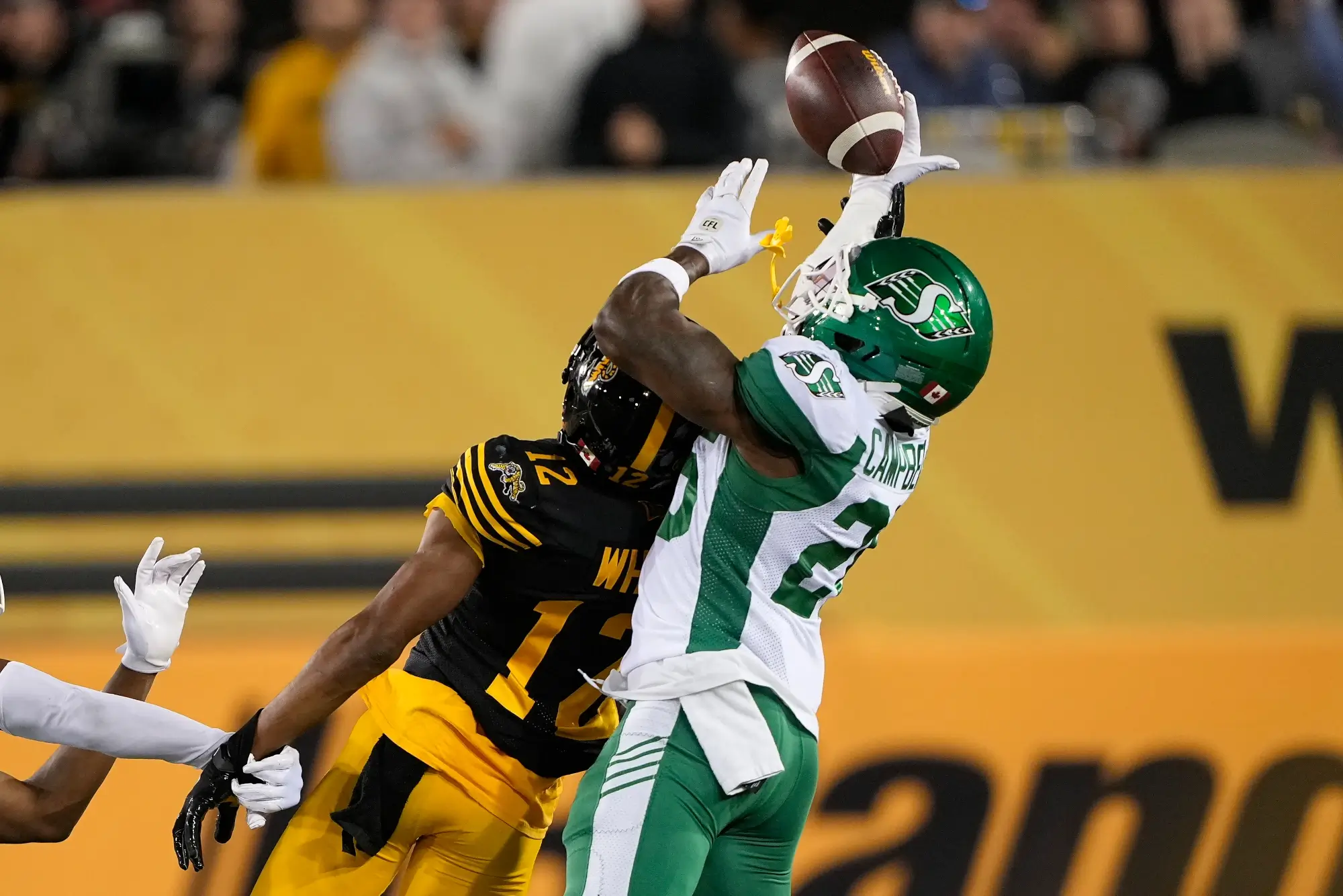 Jun 14, 2025; Hamilton, Ontario, Canada; Saskatchewan Roughriders defensive back Tevaughn Campbell (26) knocks down a pass intended for Hamilton Tiger-Cats wide receiver Tim White (12) during the second half at Hamilton Stadium.
