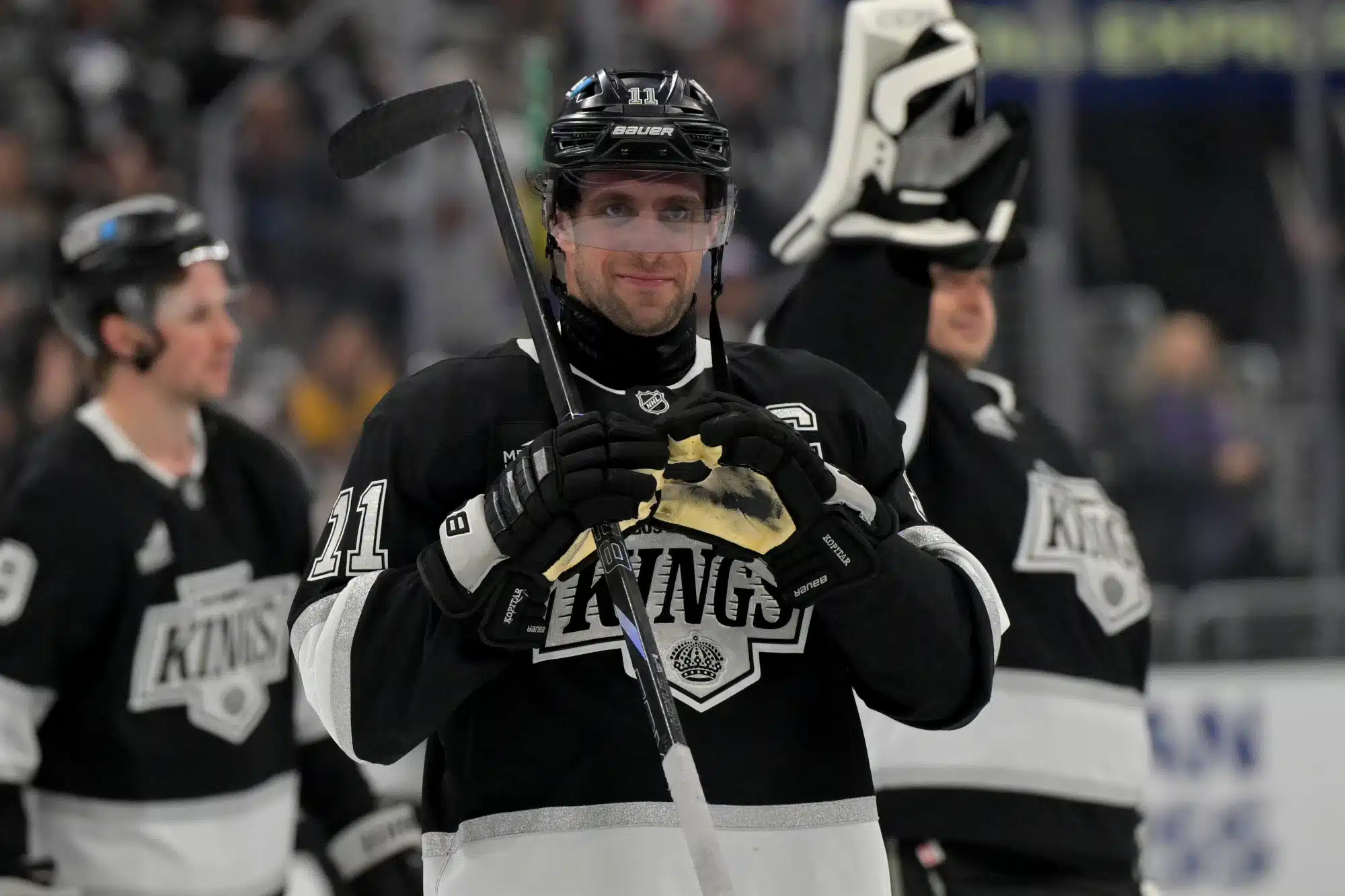 Apr 23, 2025; Los Angeles, California, USA; Los Angeles Kings center Anze Kopitar (11) makes a heart with his gloves for he daughter after defeating the Edmonton Oilers in game 2 of the 2025 Stanley Cup Playoffs at Crypto.com Arena.