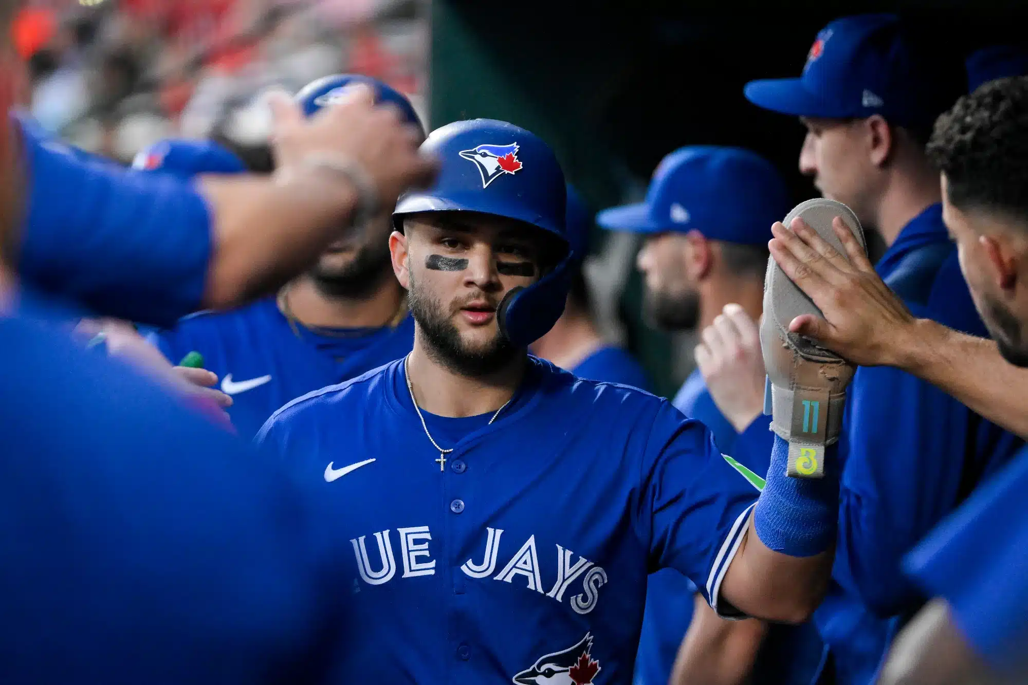Jun 10, 2025; St. Louis, Missouri, USA; Toronto Blue Jays shortstop Bo Bichette (11) is congratulated by teammates after scoring against the St. Louis Cardinals during the fifth inning at Busch Stadium.