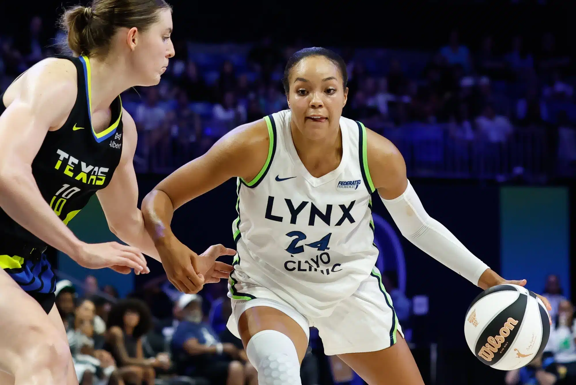 Jun 8, 2025; Arlington, Texas, USA; Minnesota Lynx forward Napheesa Collier (24) controls the ball as Dallas Wings center Luisa Geiselsoder (18) defends during the second half at College Park Center.