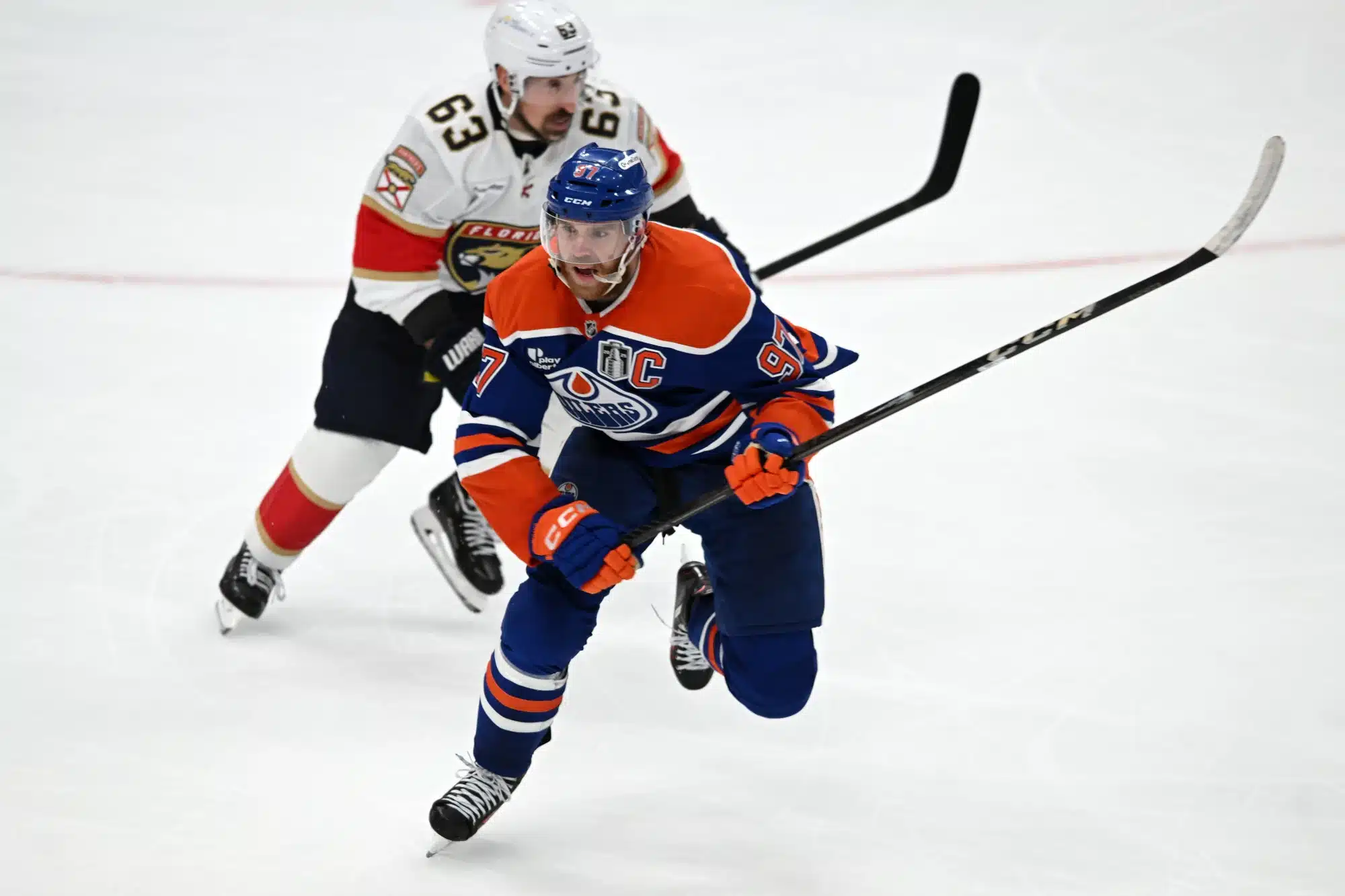 Jun 6, 2025; Edmonton, Alberta, CAN; Edmonton Oilers center Connor McDavid (97) skates past Florida Panthers center Brad Marchand (63) during the third period in game two of the 2025 Stanley Cup Final at Rogers Place.