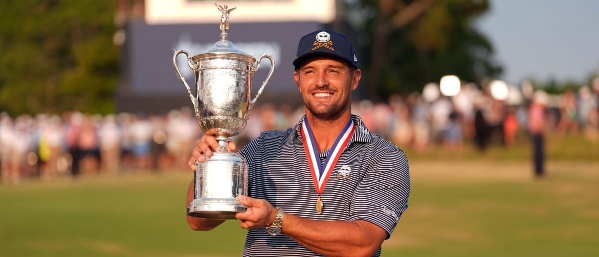 Bryson DeChambeau celebrates with the trophy after winning the U.S. Open golf tournament.