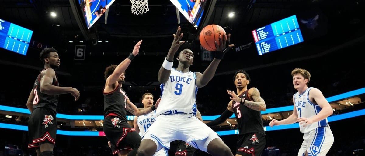 Duke Blue Devils center Khaman Maluach (9) grabs a rebound in front of Louisville Cardinals forward Aboubacar Traore (25) and guards J'Vonne Hadley (1) and Terrence Edwards Jr. (5) in the first half during the 2025 ACC Conference Championship game at Spectrum Center.