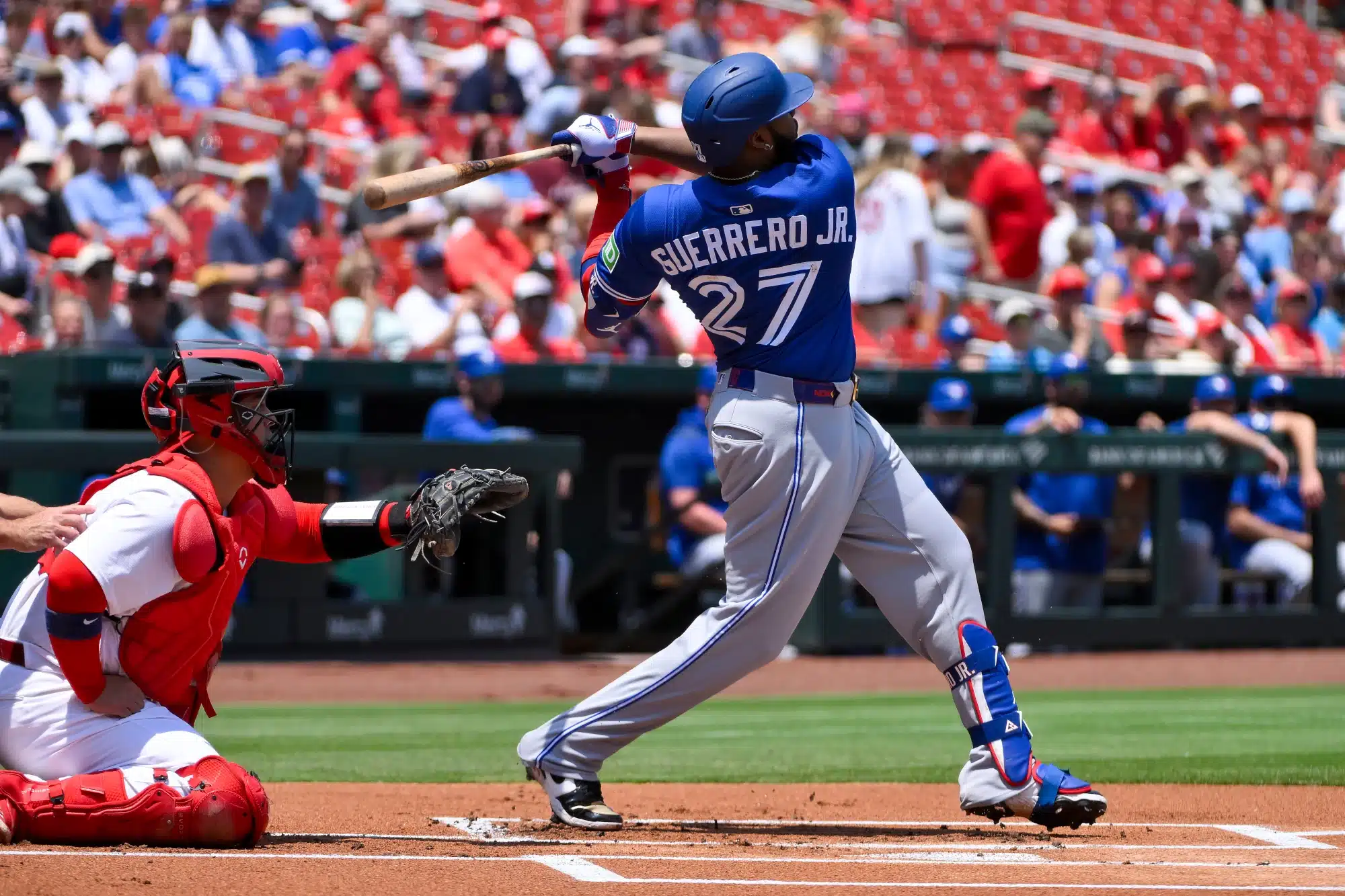 Jun 11, 2025; St. Louis, Missouri, USA; Toronto Blue Jays first baseman Vladimir Guerrero Jr. (27) hits a single against the St. Louis Cardinals during the first inning at Busch Stadium.