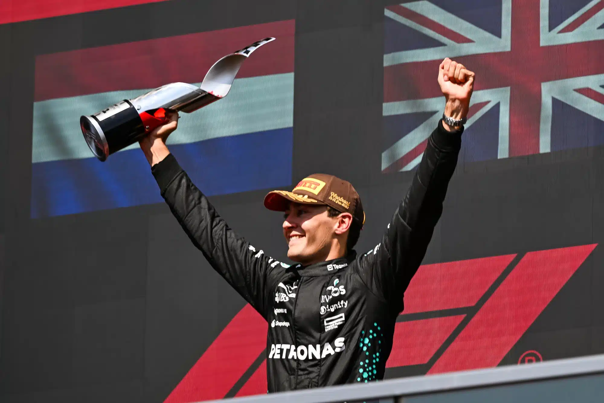 Jun 15, 2025; Montreal, Quebec, Canada; Winner of the F1 Canadian Grand Prix Mercedes driver George Russell (63) reacts after receiving his trophy at Circuit Gilles-Villeneuve.