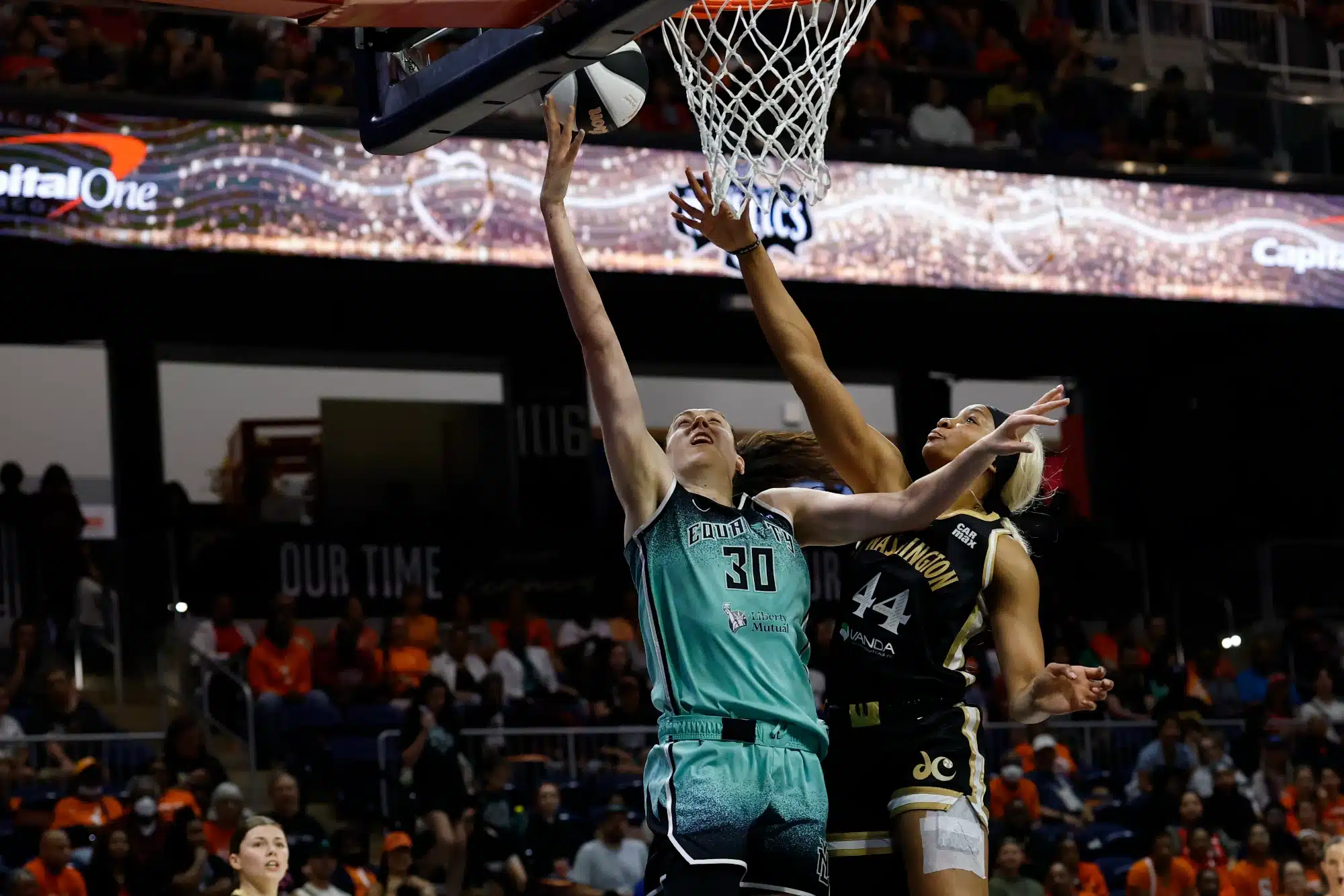 Jun 5, 2025; Washington, District of Columbia, USA; New York Liberty forward Breanna Stewart (30) shoots the ball while being fouled by Washington Mystics forward Kiki Iriafen (44) in the first half at Entertainment & Sports Arena