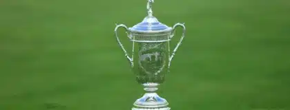A view of the US Open Championship trophy sitting on a golf green.