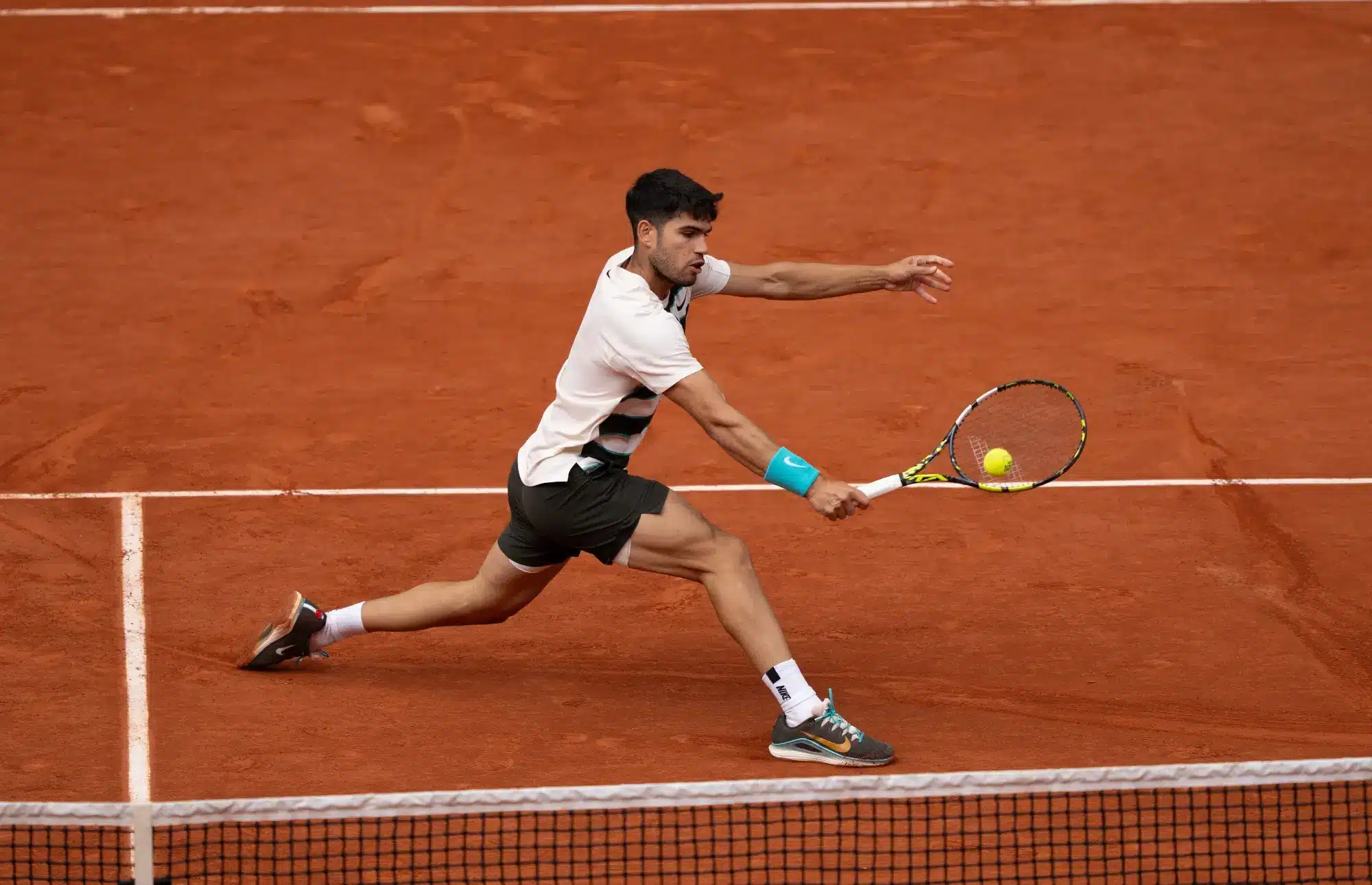 Jun 8, 2025; Paris, FR; Carlos Alcaraz of Spain returns a shot during the menís singles final against Jannik Sinner of Italy5on day 15 at Roland Garros Stadium. 