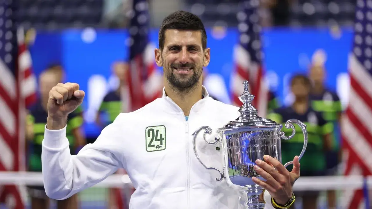 Novak Djokovic posing with the champsionship trophy in 2023 at the US Open