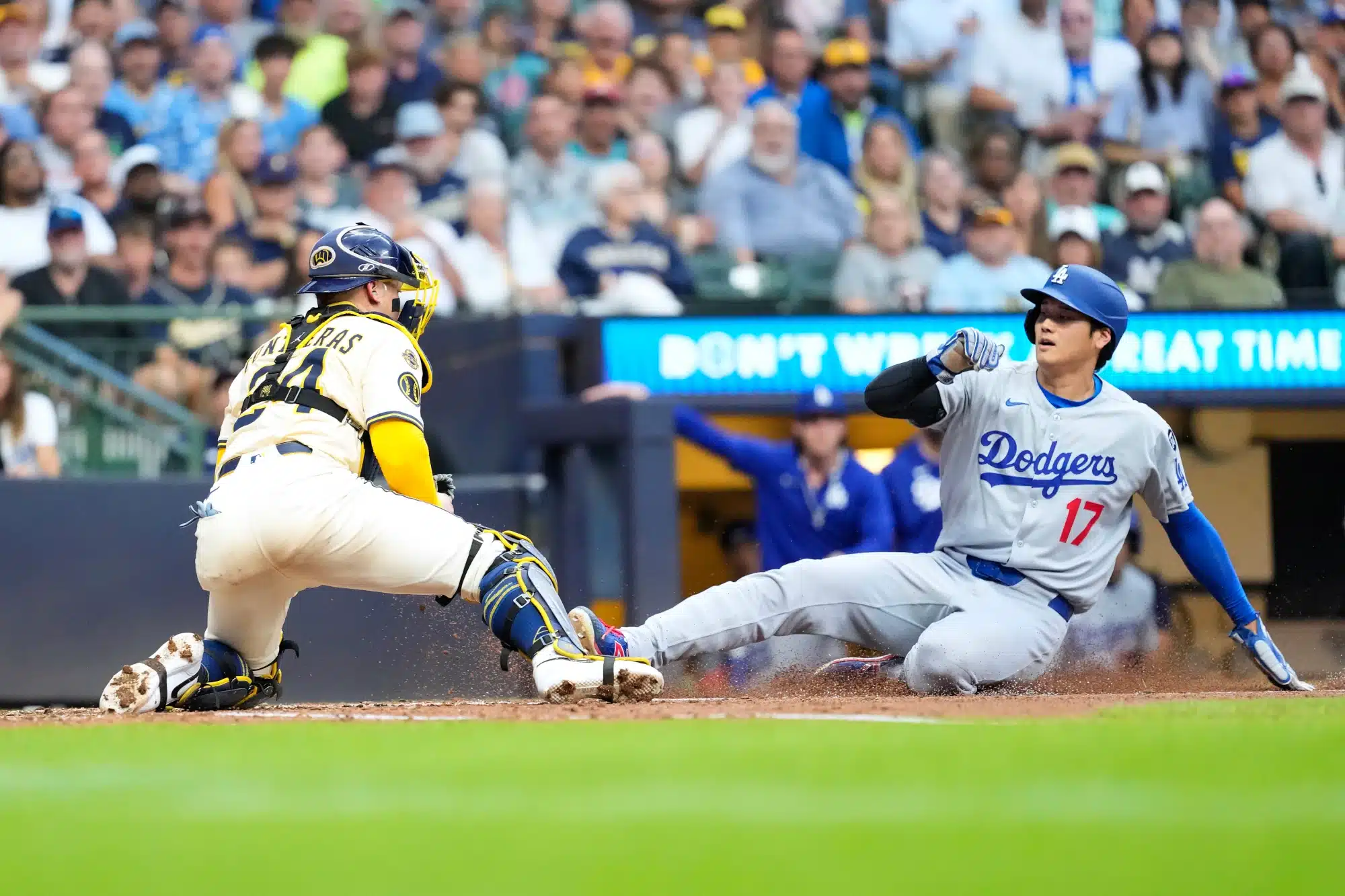Jul 8, 2025; Milwaukee, Wisconsin, USA; Los Angeles Dodgers designated hitter Shohei Ohtani (17) is tagged out by Milwaukee Brewers catcher William Contreras (24) during the sixth inning at American Family Field.