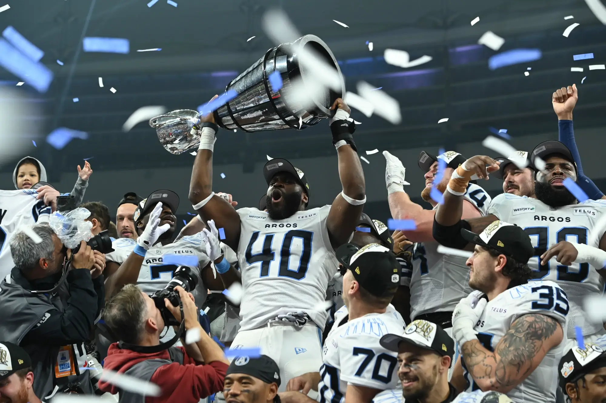 Nov 17, 2024; Vancouver, British Columbia, CAN; Toronto Argonauts defensive lineman Robbie Smith (40) lifts the Grey Cup after the win Winnipeg Blue Bombers at BC Place.