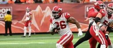 Calgary Stampeders running back Dedrick Mills (26) runs with the ball against the BC Lions during the second half at BC Place.