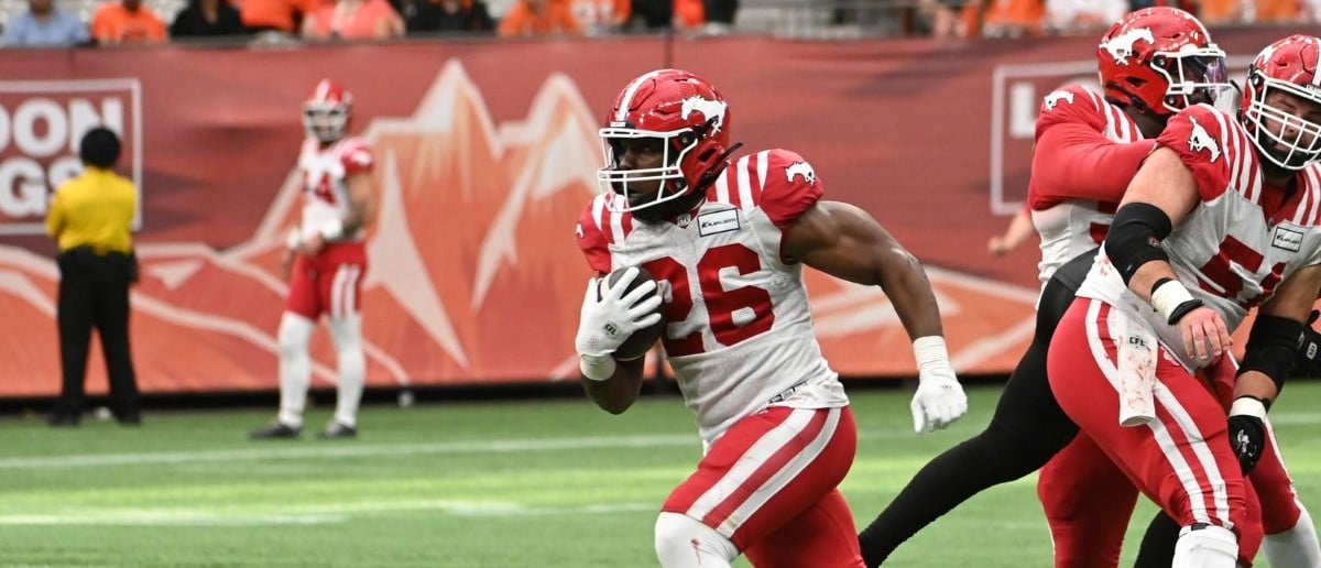 Calgary Stampeders running back Dedrick Mills (26) runs with the ball against the BC Lions during the second half at BC Place.