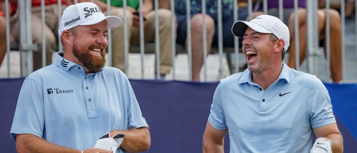 Shane Lowry laughs with Rory McIlroy, who are the defending 2024 Zurich champions, before teeing off on the first hole during the third round of the Zurich Classic of New Orleans golf tournament.