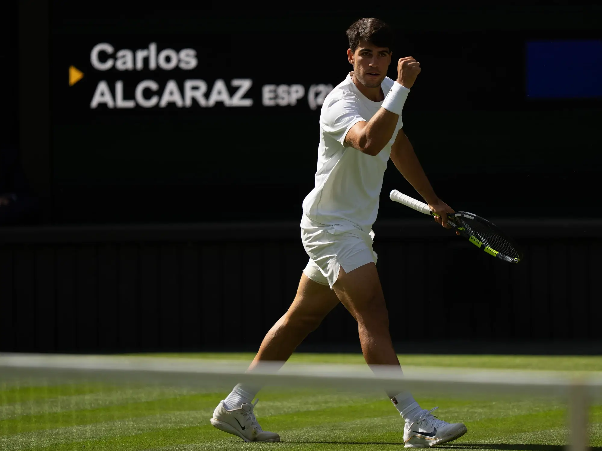 Jul 2, 2025; Wimbledon, United Kingdom; Carlos Alcaraz of Spain reacts to a point during his match against Oliver Tarvet of Great Britain on day three at the All England Lawn Tennis and Croquet Club.