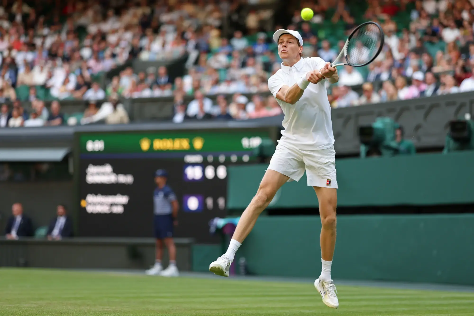 Jul 3, 2025; Wimbledon, United Kingdom; Jannik Sinner (ITA) hits a backhand against Aleksandar Vukic (AUS) on day four of The Championships Wimbledon 2025 at All England Lawn Tennis and Croquet Club.