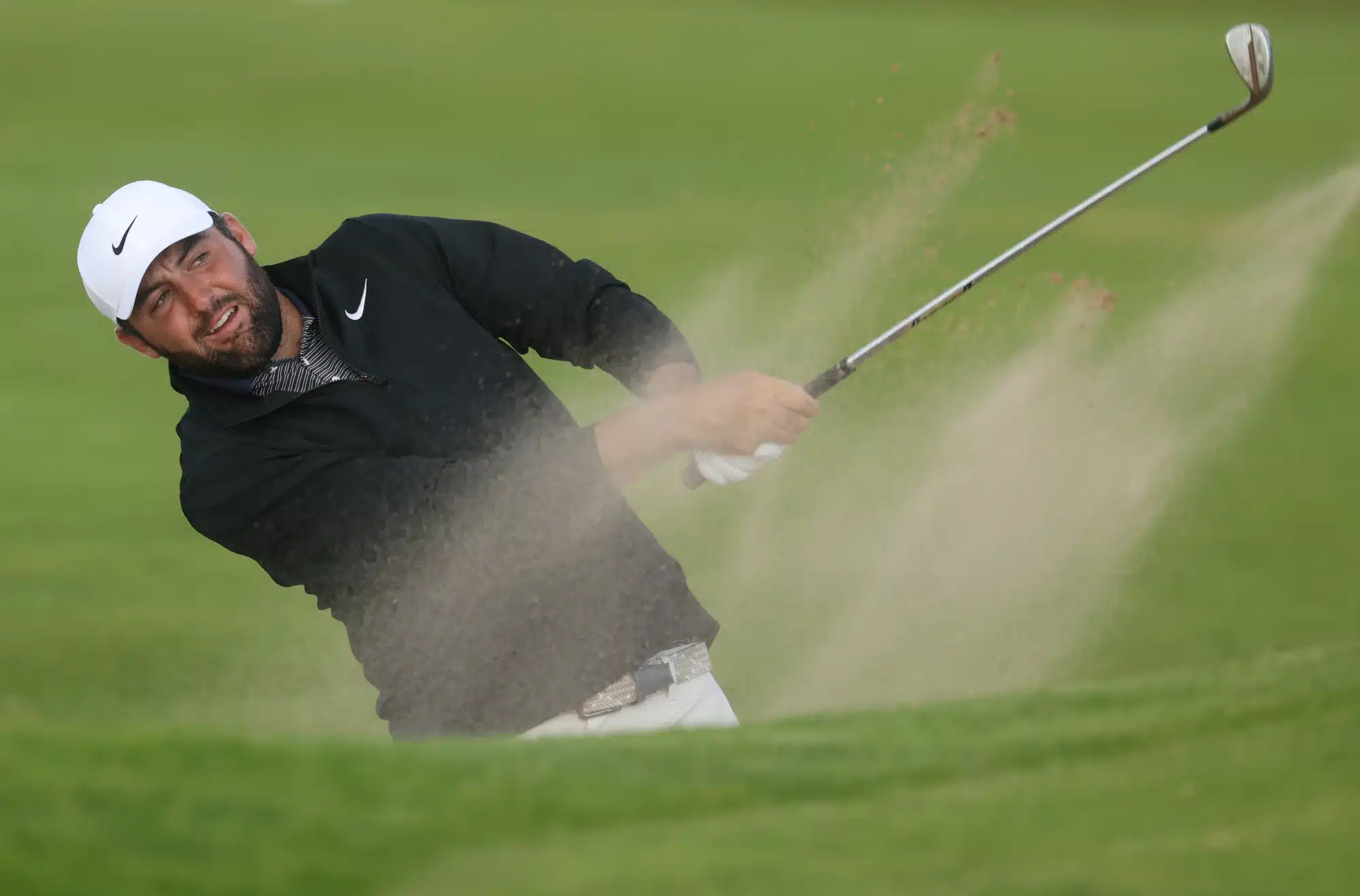 Jul 19, 2025; Portrush, IRL; Scottie Scheffler hits from a bunker on the 12th hole during the third round of The 153rd Open Championship golf tournament. 