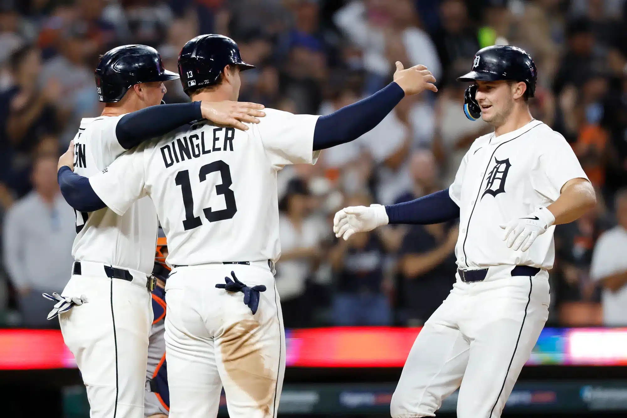 Aug 18, 2025; Detroit, Michigan, USA; Detroit Tigers shortstop Trey Sweeney (27) celebrates with catcher Dillon Dingler (13) and first baseman Spencer Torkelson (20) after he hit a three run home run in the seventh inning against the Houston Astros at Comerica Park. 