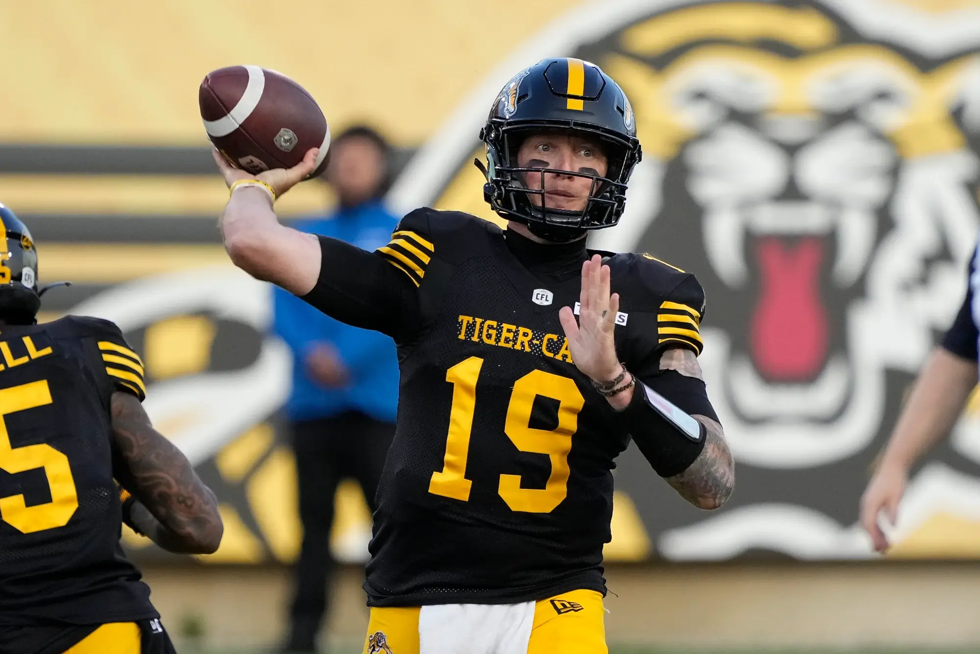 Jun 14, 2025; Hamilton, Ontario, Canada; Hamilton Tiger-Cats quarterback Bo Levi Mitchell (19) throws a pass against the Saskatchewan Roughriders during the first half at Hamilton Stadium. 