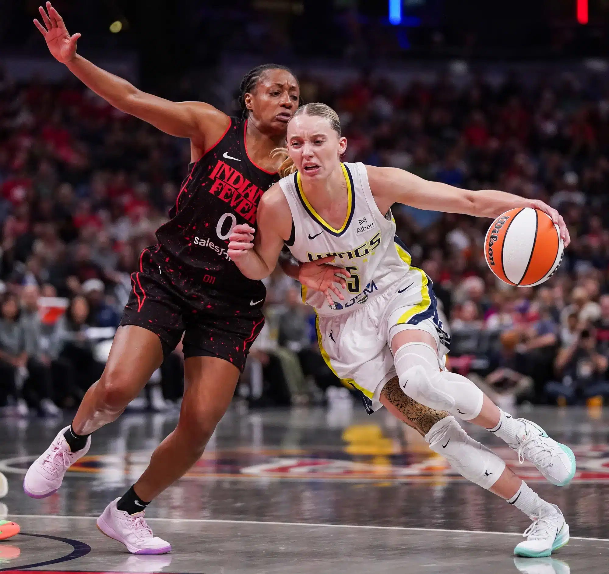 Indiana Fever guard Kelsey Mitchell (0) rushes up the court against Dallas Wings guard Paige Bueckers (5) on Tuesday, Aug. 12, 2025, during the game at Gainbridge Fieldhouse in Indianapolis. The Dallas Wings defeated the Indiana Fever, 81-80.