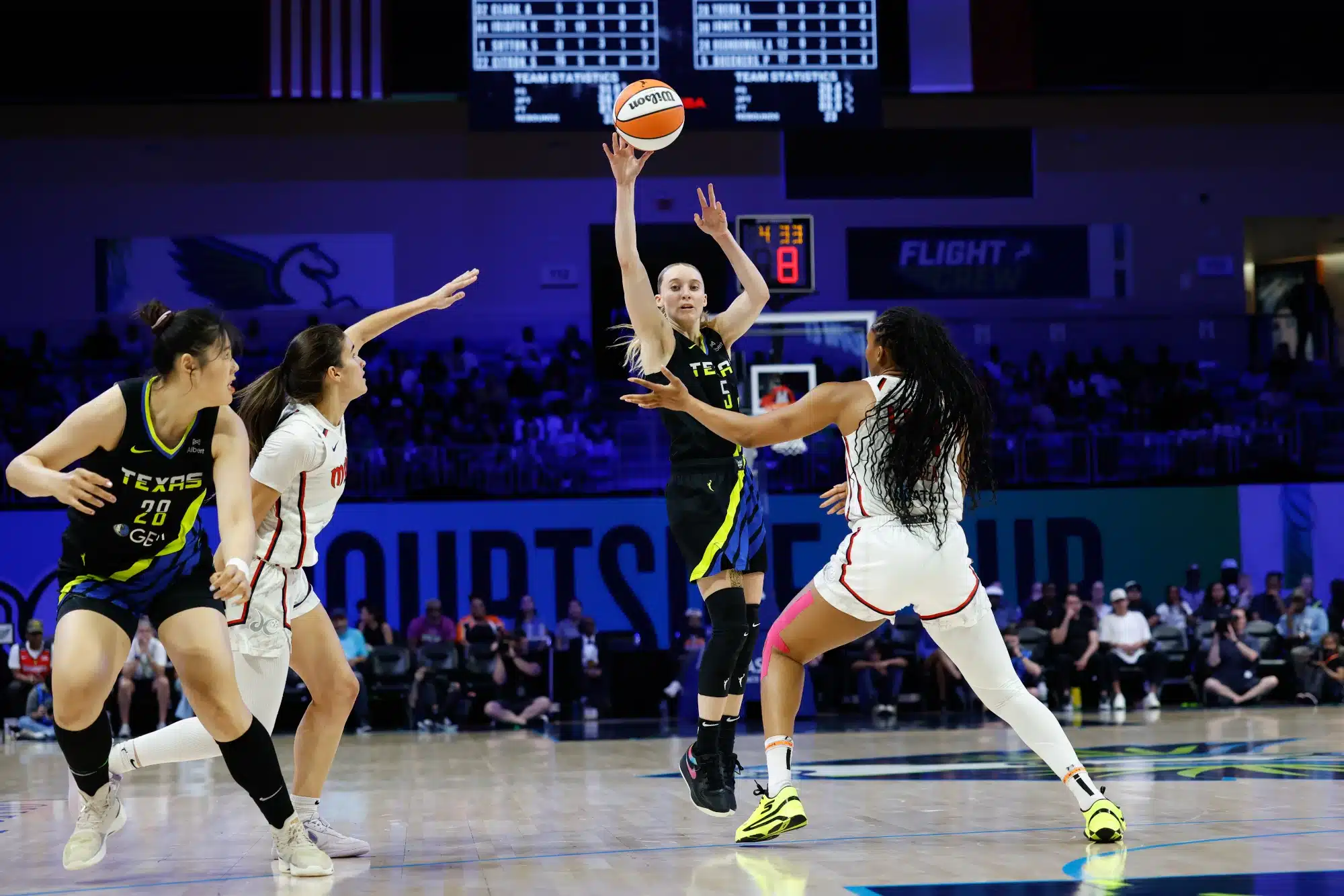 Aug 10, 2025; Arlington, Texas, USA; Dallas Wings guard Paige Bueckers (5) looks to pass against Washington Mystics forward Kiki Iriafen (44) during the second half at College Park Center.