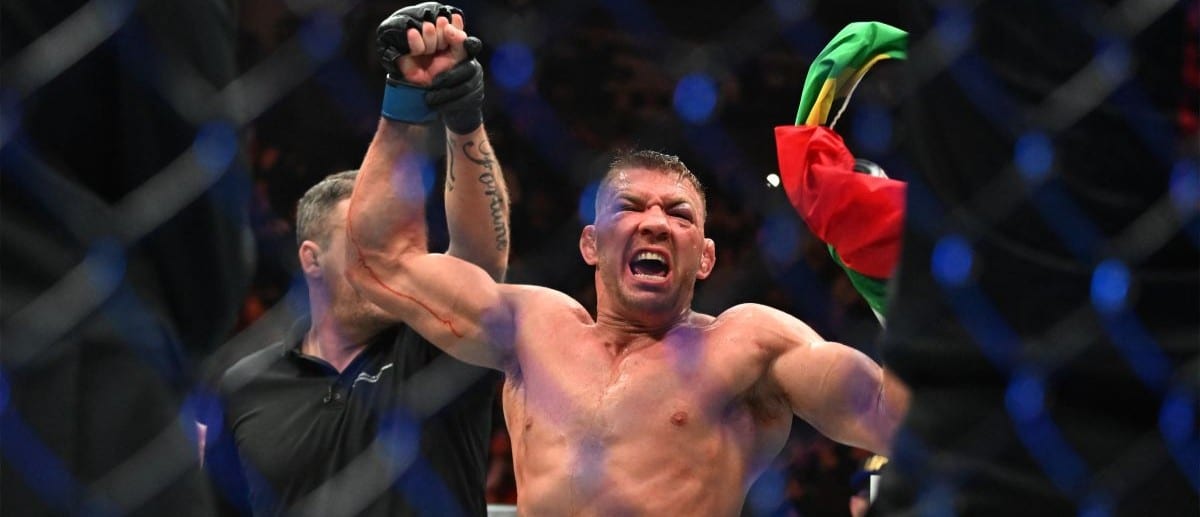 Dricus Du Plessis (blue gloves) celebrates defeating Sean Strickland (red glove) during UFC 297 at ScotiaBank Arena.